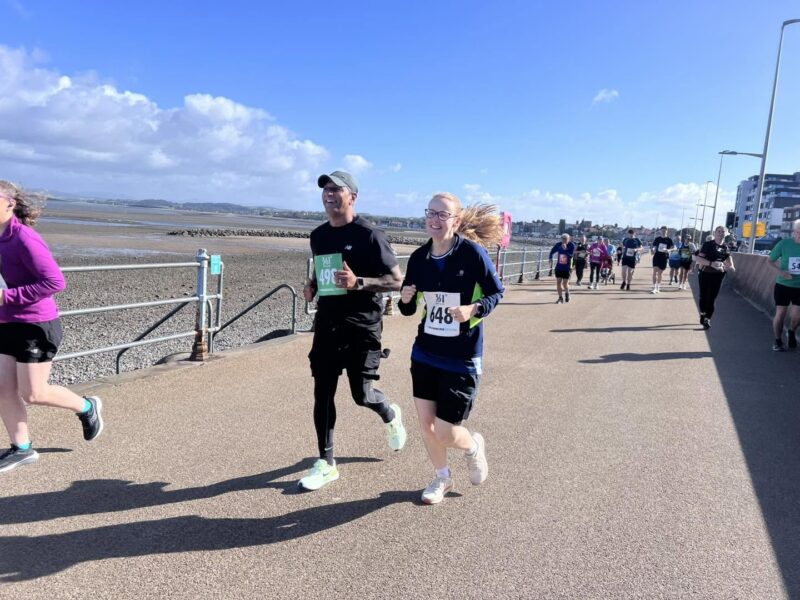  Cat Smith MP and Yak Patel, Chief Executive of Lancaster District CVS running 10k on Morecambe Promenade